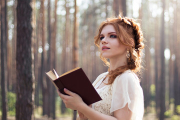 Red-haired girl reads a book, a photo in vintage style, a vintage girl