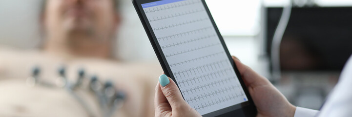 Focus on medical device in doctor hands. Specialist applying newest method of cardiogram with technological advantages. Medicine and healthcare concept