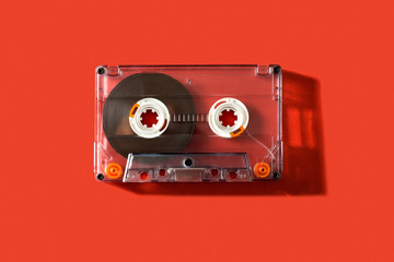 Old vintage cassette tape on a red background