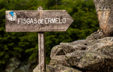 Wood road sign indicating 