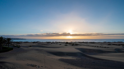 Fototapeta na wymiar Sunrise in the dunes of Maspalomas, Gran Canaria