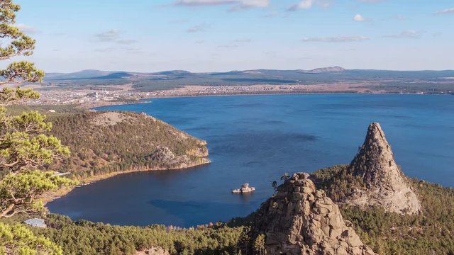 Majestic nature of Kazakhstan concept: epic view of Burabay lake with Okzhetpes and Zhumbaktas rocks from the highest point of Sinyuha Mountain at sunset in autumn season; time lapse zoom out
