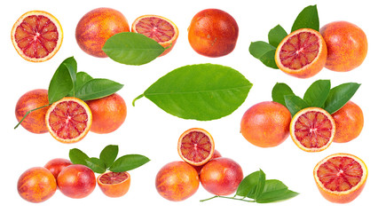 Set of sliced and unpeeled ripe blood oranges with green leaves isolated on white background