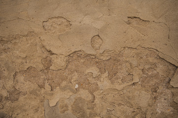 old plaster surface with defects,concrete beige surface with signs of destruction,concrete beige surface with signs of destruction
