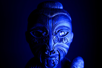 Studio shot of mystic hawaiian wood tattooed sculpture with mace illuminated by blue light - obrazy, fototapety, plakaty