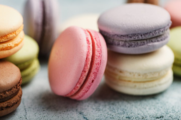 Multicolored French macaron cookies close-up, filling macro.