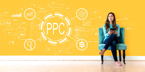 PPC - Pay per click concept with young woman holding a tablet computer - obrazy, fototapety, plakaty
