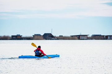 Fototapeta na wymiar Man with kayak on lake neusiedlersee in Burgenland