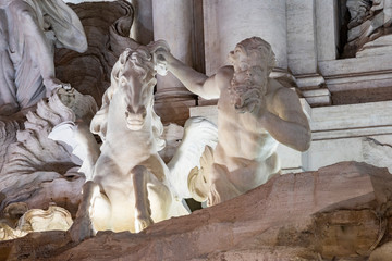 Detail view of the statue Horse with Triton, Trevi Fountain, Rome, Italy. Large marble fountain from the Baroque period.