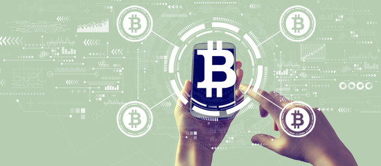 Bitcoin theme with person holding a white smartphone