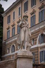 Fototapeta na wymiar Allegorical statue in summer, Piazza del Popolo in Rome, Italy.