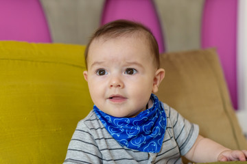 Small, smiling baby sitting