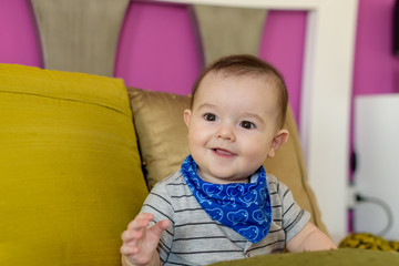 Small, smiling baby sitting