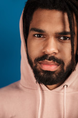 Portrait of african american man in hood posing and looking at camera