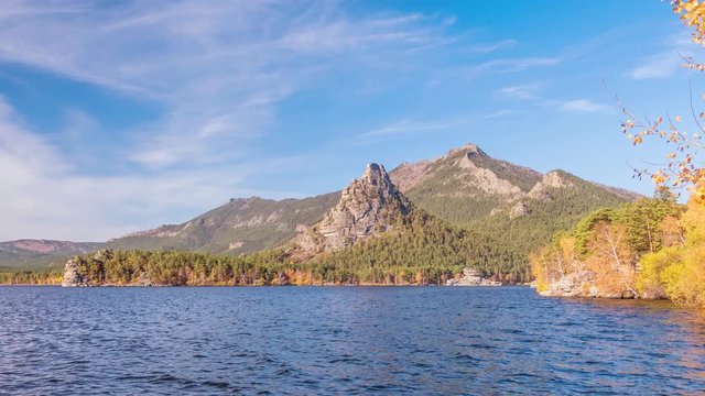 Majestic nature of Kazakhstan concept: epic view of Burabay lake with Okzhetpes and Zhumbaktas rocks from the highest point of Sinyuha Mountain at sunset in autumn season; time lapse zoom out