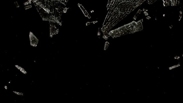 Textured Glass breaking in slow motion on black background