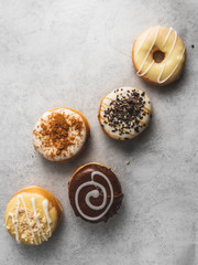 donuts with icing on grey background