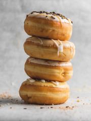 stack of donuts on grey background