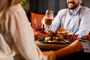 Beautiful loving couple is spending time together in modern restaurant