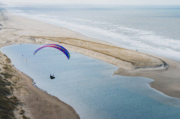 Soaring. Paragliding on the dunes in Holland.