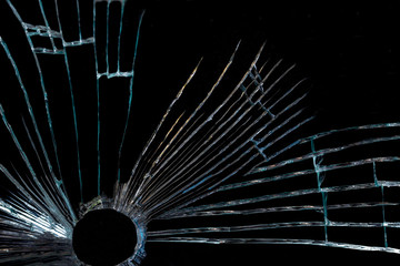 a crack on a broken glass mirror , on a black background in the form of an abstraction as a drawing in the form of an image