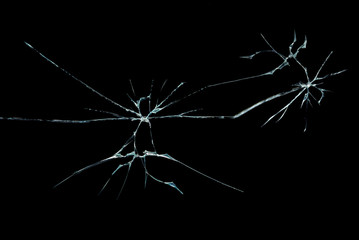 a crack on a broken glass mirror , on a black background in the form of an abstraction as a drawing in the form of an image