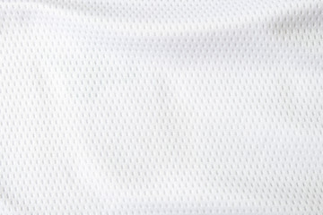 Fototapeta na wymiar Selective focus, White mesh fabric background. cloth sport wear texture for exercise. light weight, good air flow, cool and easy to dry from sweat. abstract wallpaper with copy space for text.