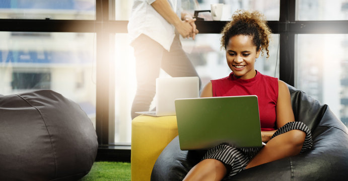 African businesswoman is using a laptop to work, the office space is modern and happy. Working independently will increase skills, ideas, and work more efficiently. And succeed. copy space