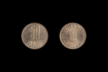 old coin fifty bani, Romania on a black background. close-up on two sides.