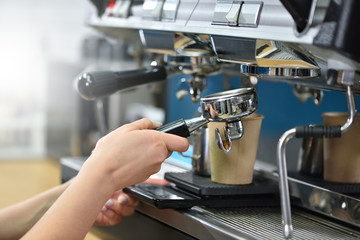 Barista makes coffee on a coffee machine. Hands close-up