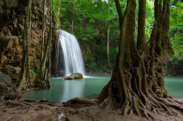 A beautiful waterfall deep in the tropical forest, steep mountain adventure in the rainforest.