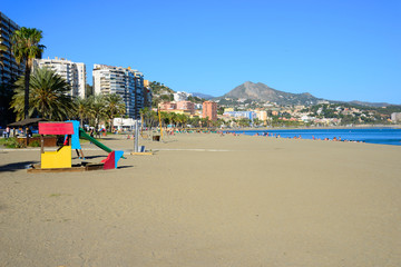 Malaga, Spain - March 4, 2020: Bathers on the beach of La Malagueta in the city of Malaga.