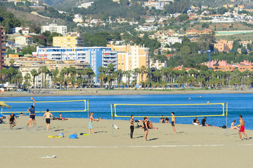 Malaga, Spain - March 4, 2020: Bathers on the beach of La Malagueta in the city of Malaga.