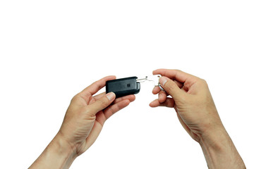adult hand pulling a car key from slot in remote body on white background isolated with clipping path