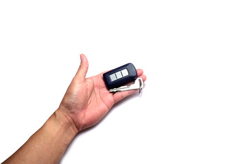 adult hand pulling a car key from slot in remote body on white background isolated with clipping path