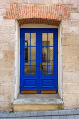 Fototapeta premium Blue door with brick wall at Lviv, Ukraine.