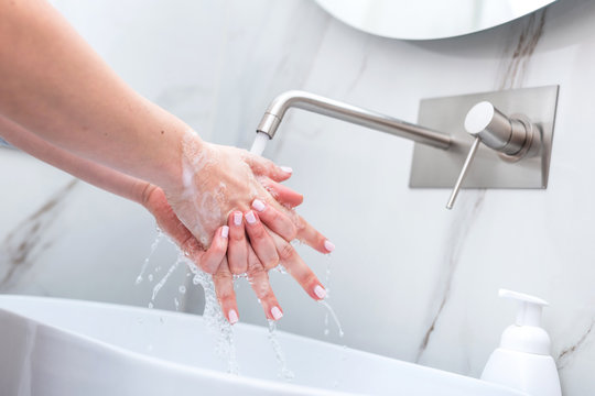Woman washing hands with foam soap. Hygiene, preventing coronavirus