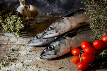 fish on wooden table with vegetables