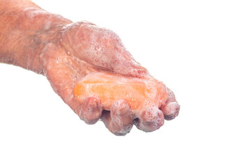 Senior woman washing hands using soap on white background, hygiene concept