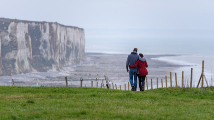 Couple of lovers strolling along the  chalk cliffs of Ault in the Somme department in Hauts-de-France in northern France.