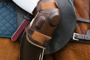 Horse polo player with riding boots and knee caps: protective equipment closeup