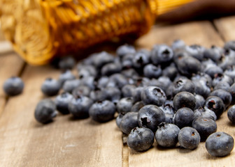 Fototapeta na wymiar Blueberries berries scattered on wooden boards