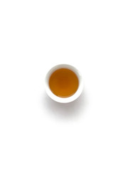 small white cup of tea top a chinese ceremony on a white background isolated