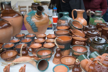 Pottery jugs at the fair. Handicrafts of folk potters.