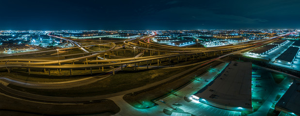 Aerial picture of highway intersection at night near Fort Worth in Texas with lightspurs