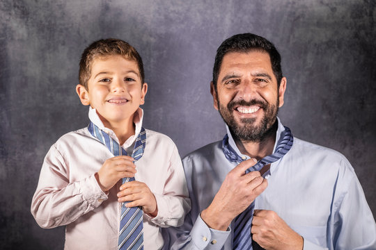 Father And Son Putting On A Tie. Fathers Day Concept.