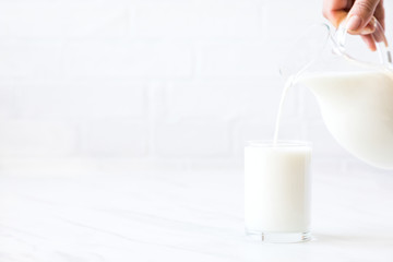 Female hand pours Almond milk .Drink for vegetarians.