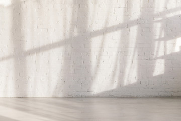 sunlight and shadows on brick wall in empty yoga studio - obrazy, fototapety, plakaty