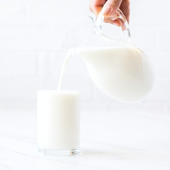 Female hand pours Almond milk .Drink for vegetarians.