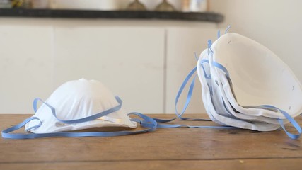Number of face masks lying on the table, slider shot.